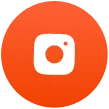 Orange circular icon with a white camera symbol inside representing a photo or camera app.
